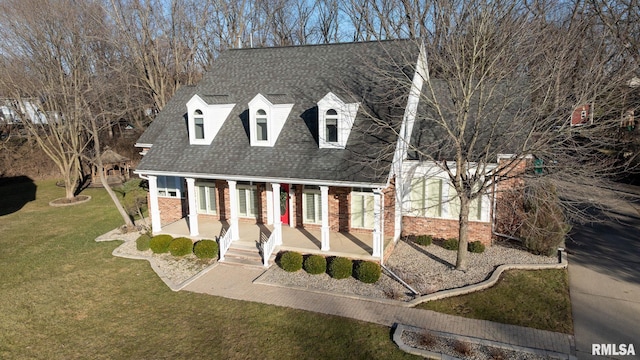 view of front of home with a porch and a front yard