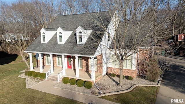 cape cod house with a porch and a front yard