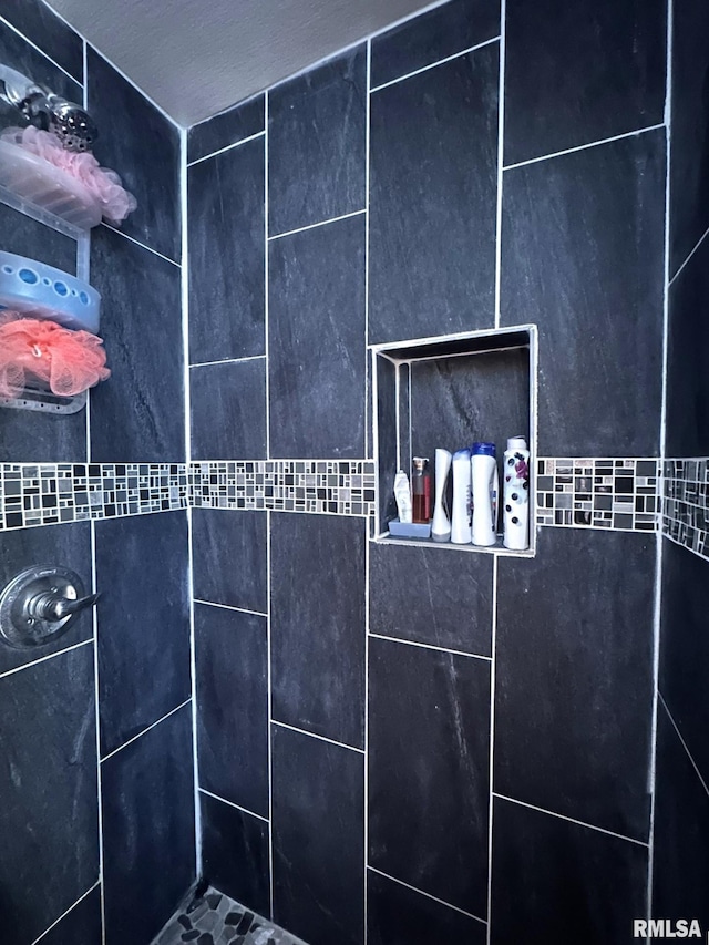 interior details with a tile shower