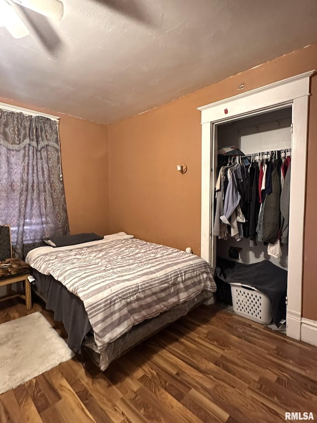 bedroom with ceiling fan, a closet, and wood finished floors