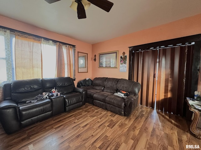 living area featuring wood finished floors and a ceiling fan