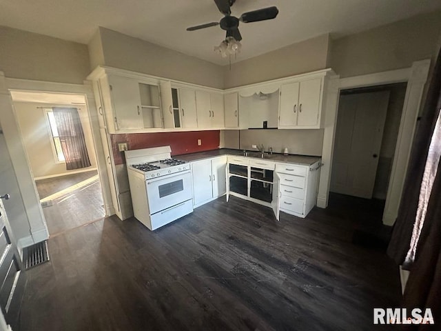 kitchen featuring sink, white gas range oven, ceiling fan, white cabinetry, and dark hardwood / wood-style flooring