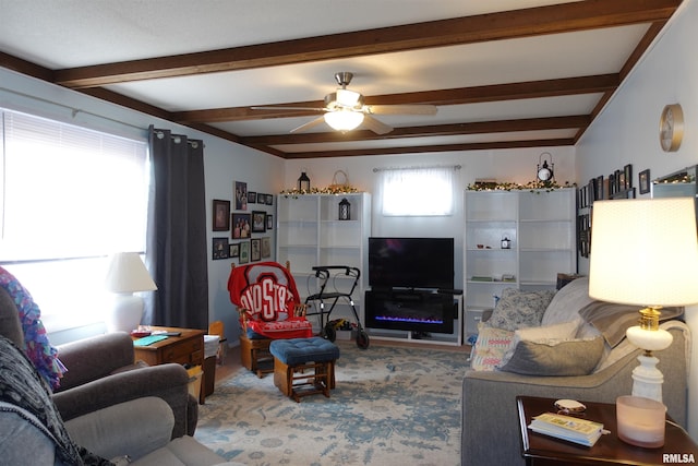 living room featuring beamed ceiling and ceiling fan