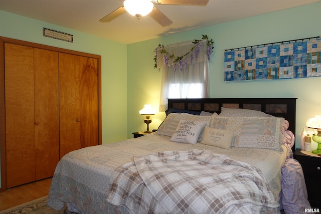 bedroom featuring ceiling fan, hardwood / wood-style floors, and a closet