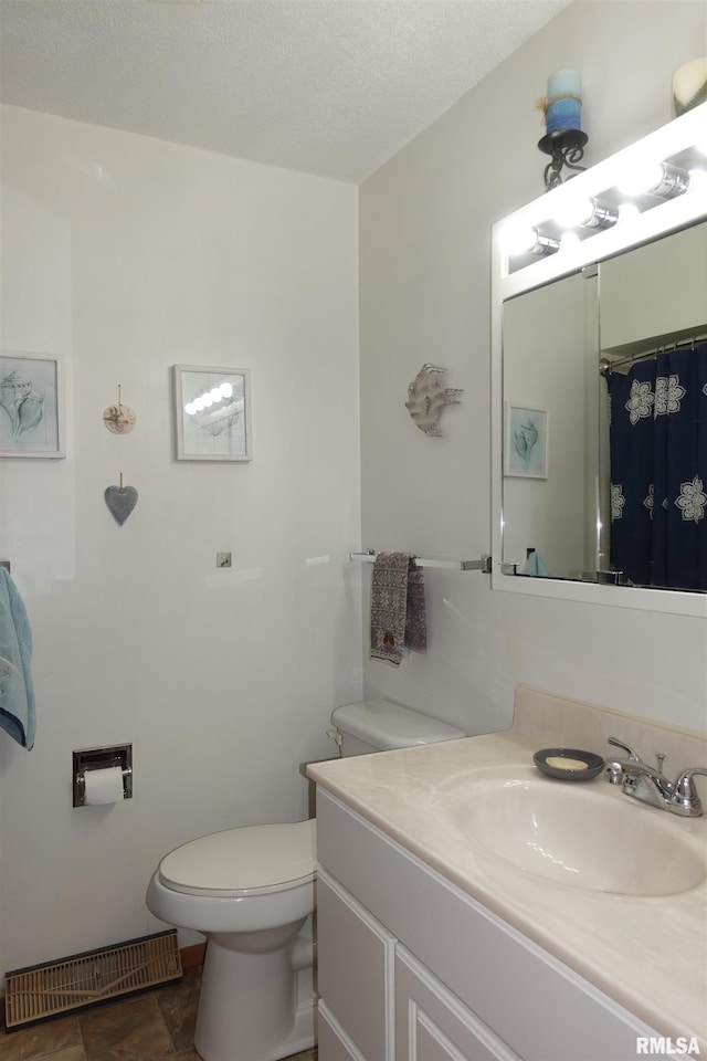 bathroom with vanity, a textured ceiling, a shower with curtain, and toilet