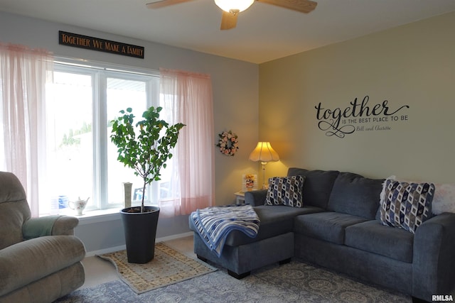 living room featuring plenty of natural light and ceiling fan