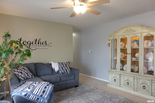 living room with ceiling fan and carpet