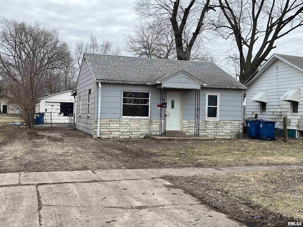 bungalow with an outbuilding and a garage