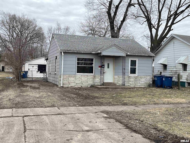 bungalow with an outbuilding and a garage