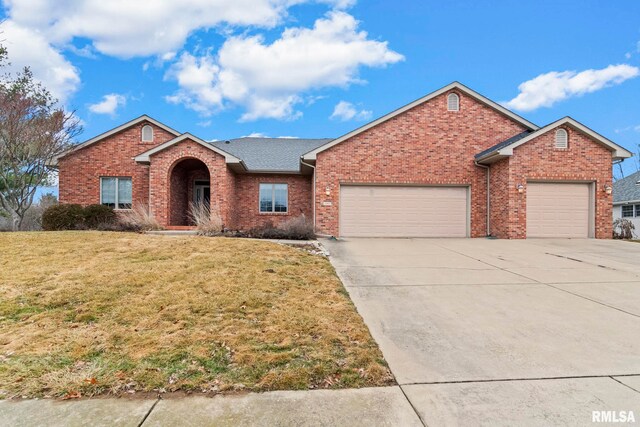 ranch-style home featuring a garage and a front lawn