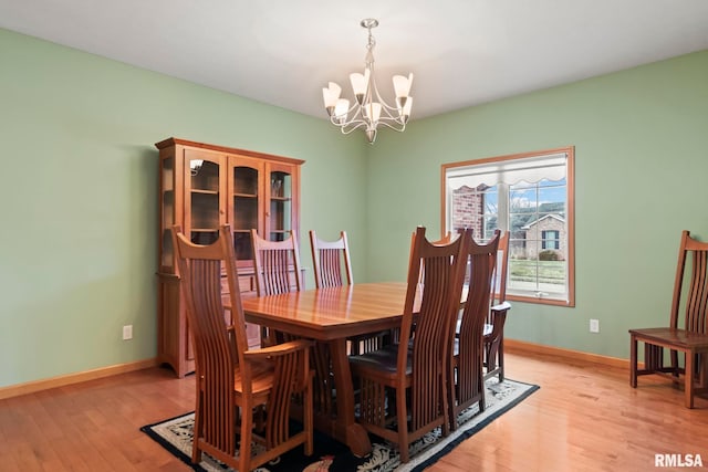 dining room featuring an inviting chandelier and light wood-type flooring