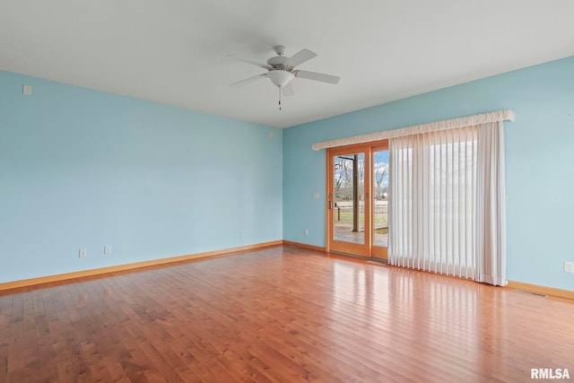 empty room featuring light hardwood / wood-style flooring and ceiling fan