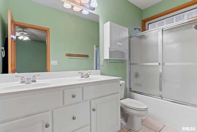 full bathroom featuring tile patterned flooring, vanity, enclosed tub / shower combo, and toilet