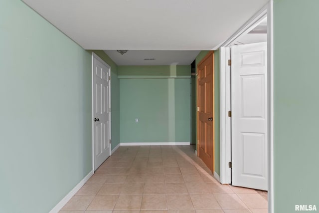 corridor with light tile patterned flooring