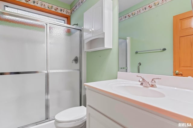 bathroom with vanity, toilet, and walk in shower