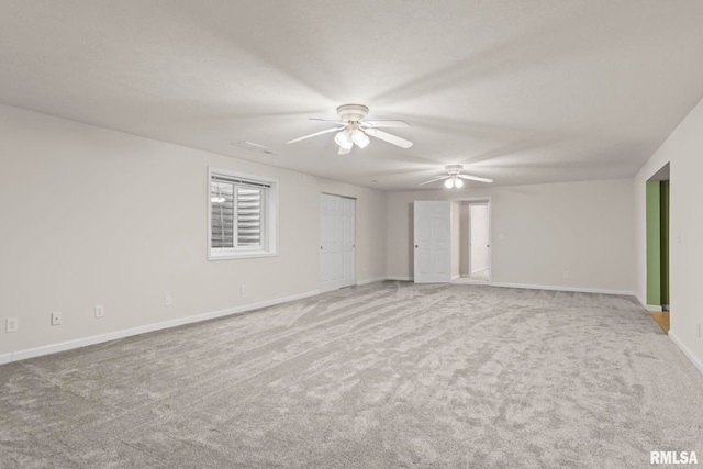 spare room with light carpet and ceiling fan