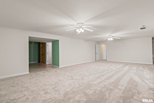 unfurnished room with light colored carpet and ceiling fan