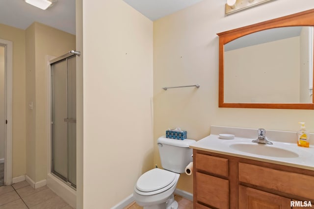 bathroom with vanity, toilet, tile patterned floors, and a shower with shower door