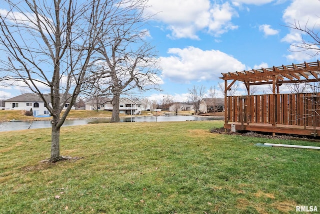 view of yard with a water view and a pergola