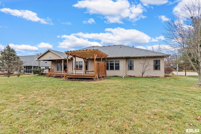 back of house with a pergola, a lawn, and a deck