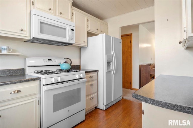 kitchen with hardwood / wood-style floors and white appliances