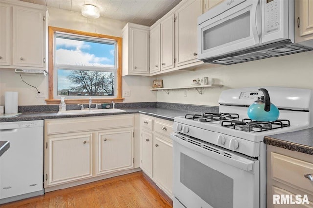 kitchen featuring light wood-type flooring, white appliances, sink, and white cabinets