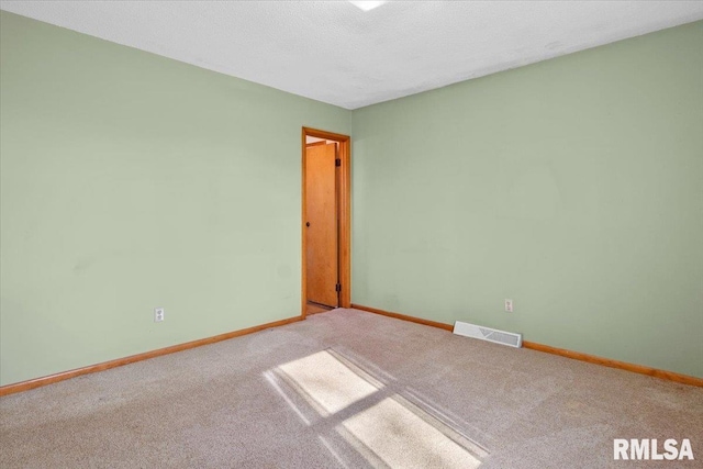 spare room with carpet flooring and a textured ceiling