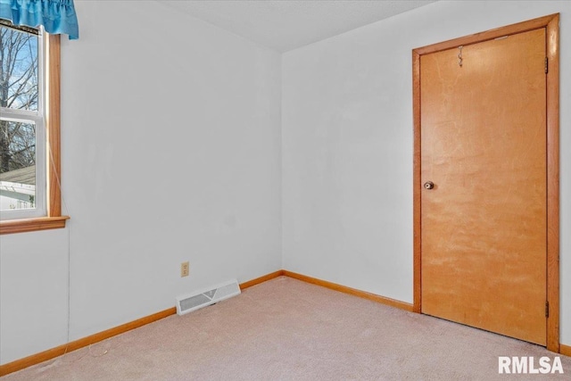 empty room featuring light colored carpet