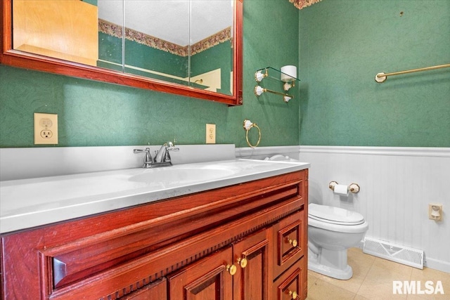 bathroom featuring vanity, toilet, and tile patterned flooring