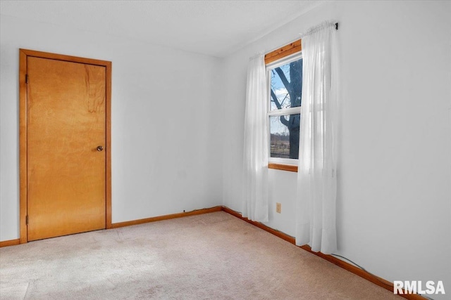 unfurnished room with light colored carpet