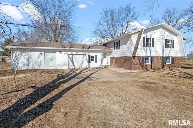 rear view of house featuring a garage