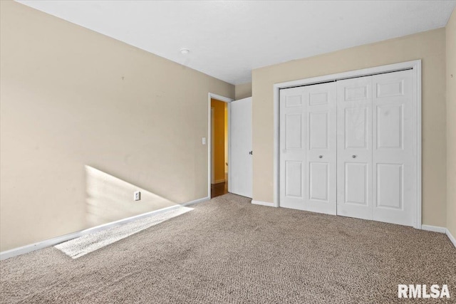 unfurnished bedroom with baseboards, a closet, and carpet floors