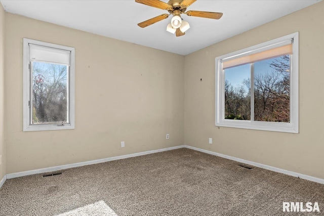 unfurnished room with visible vents, baseboards, carpet, and ceiling fan