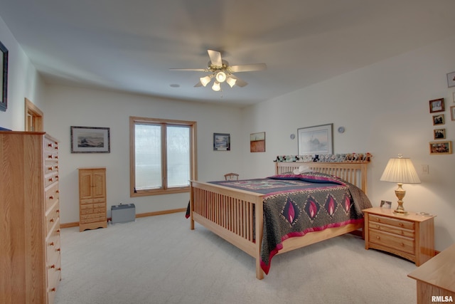 bedroom featuring light colored carpet and ceiling fan