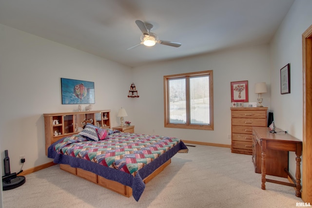 bedroom featuring light colored carpet and ceiling fan