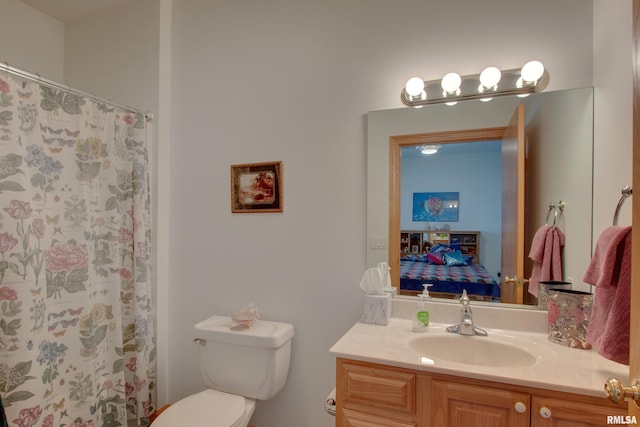 bathroom with vanity, toilet, and curtained shower