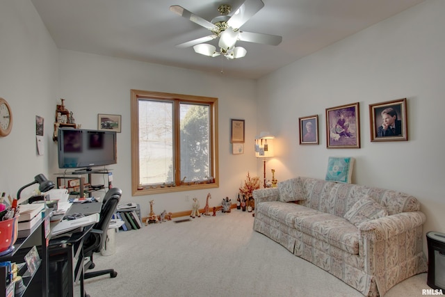 carpeted office space with ceiling fan