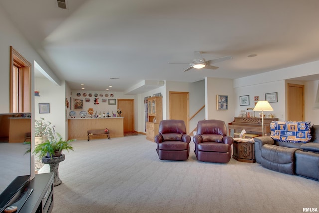 living room with ceiling fan and carpet