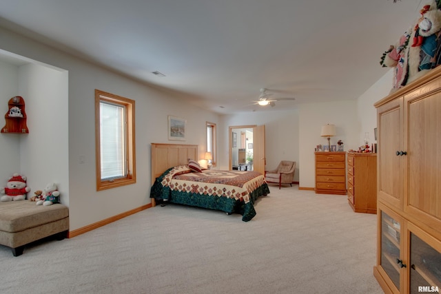 bedroom with multiple windows, light carpet, and ceiling fan