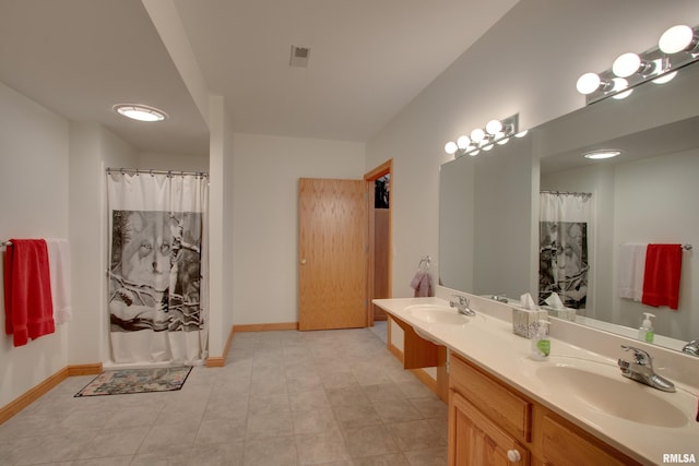 bathroom with vanity and curtained shower