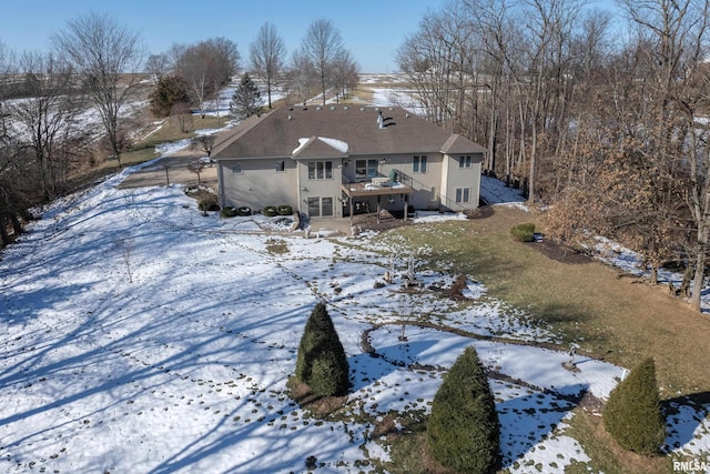 snow covered property featuring a deck