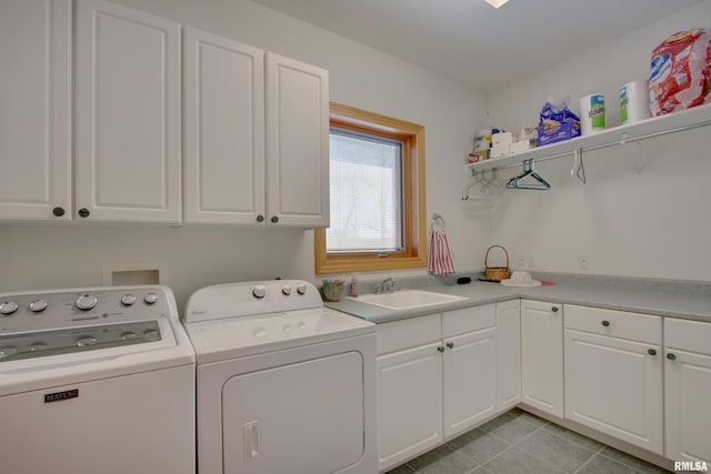 clothes washing area featuring cabinets, washer and clothes dryer, sink, and light tile patterned floors