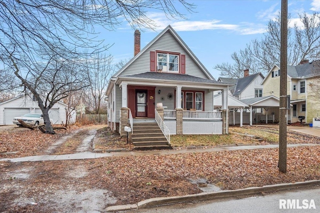 bungalow-style house with an outbuilding, a porch, and a garage