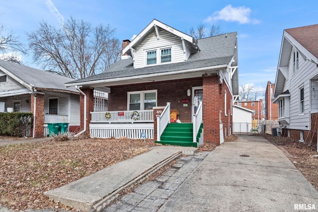 bungalow featuring central air condition unit and a porch