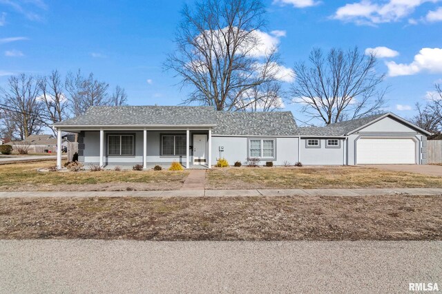 ranch-style home with a garage, a porch, and a front yard