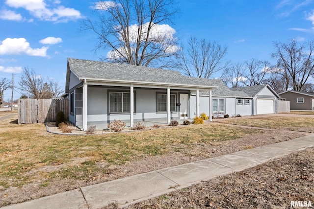 ranch-style home featuring a garage, a front lawn, and covered porch