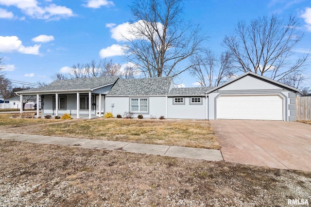 ranch-style home featuring a garage, covered porch, and a front lawn