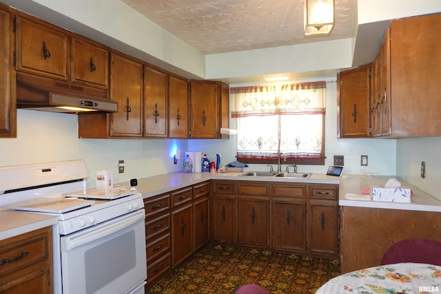 kitchen with sink, a textured ceiling, and white stove