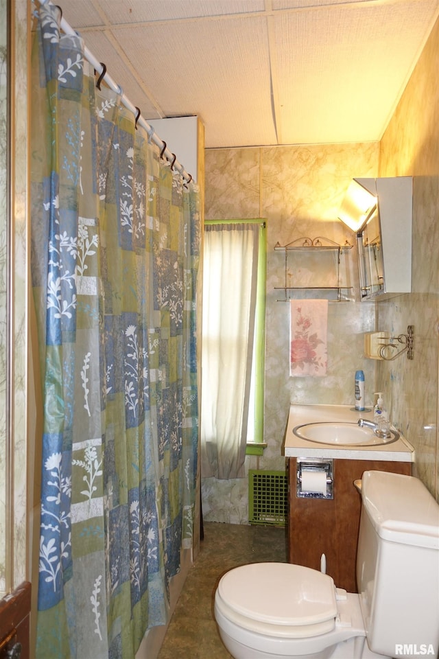 bathroom featuring tile walls, sink, toilet, and a shower with shower curtain