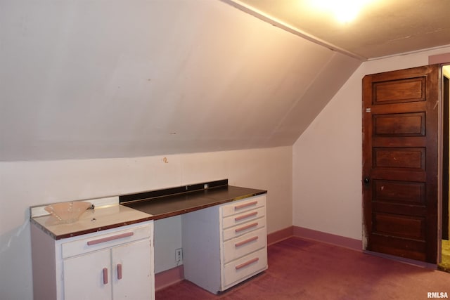 unfurnished office featuring lofted ceiling and carpet floors